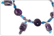 Beads designed with are amethyst and aqua bicone crystal beads, round beads, and round/rectangular amethyst beads.